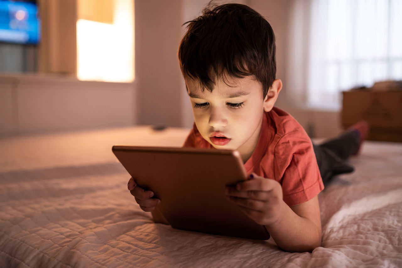 Young boy looking at a mobile device
