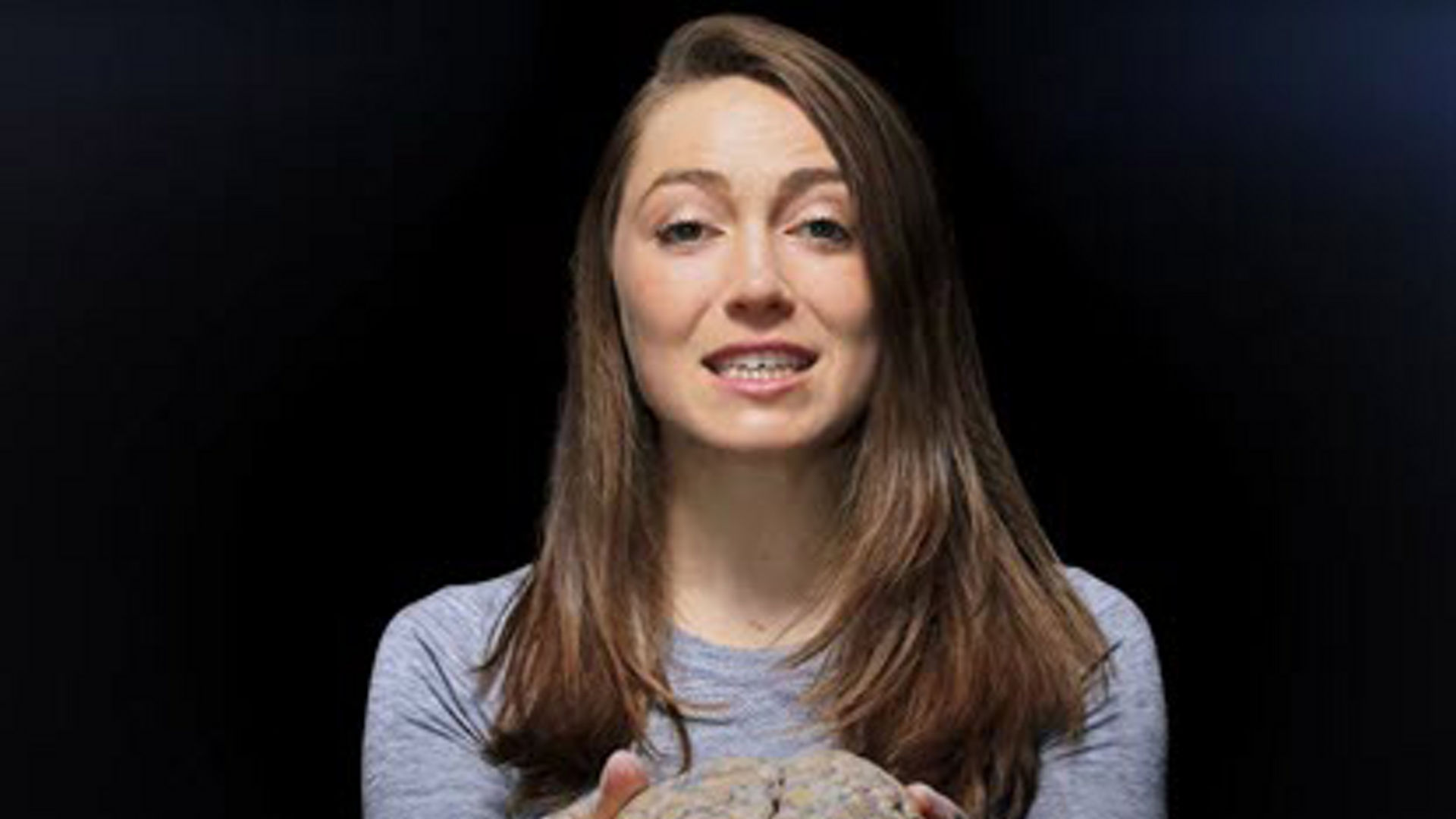 Woman holding example of a brain