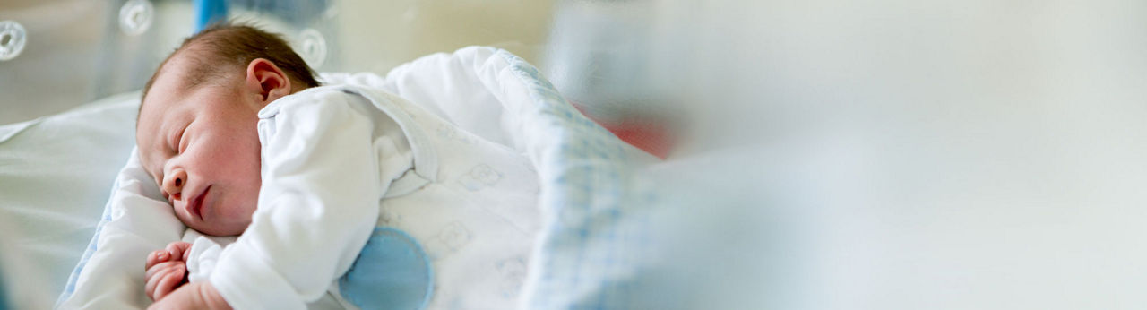 Newborn baby in a crib