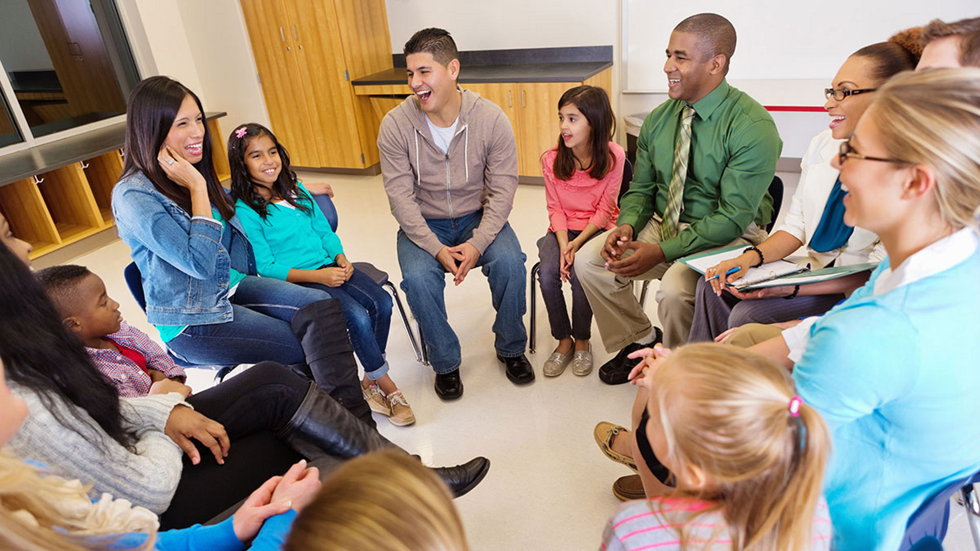 group of people sitting in a circle talking