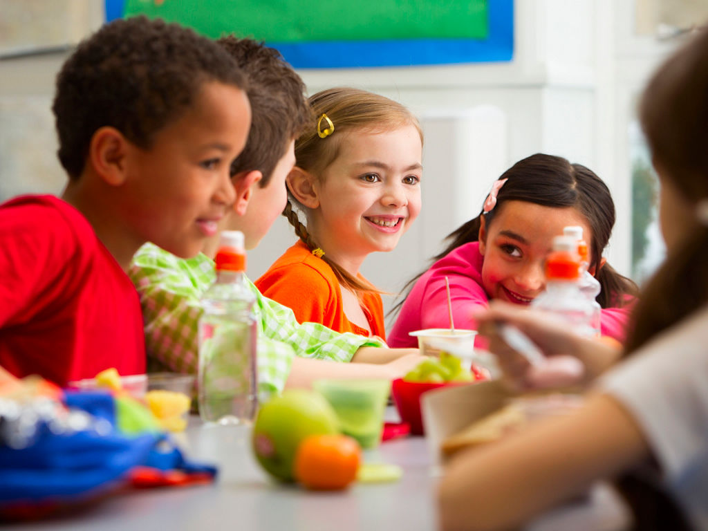 Children eating healthy boxed lunches