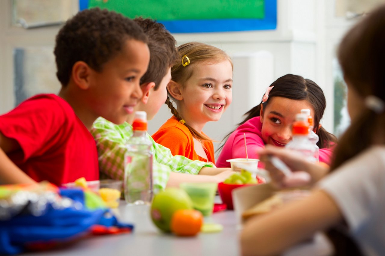 Group of children having packed lunches