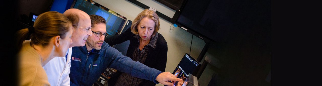 Health professionals looking at computer monitor