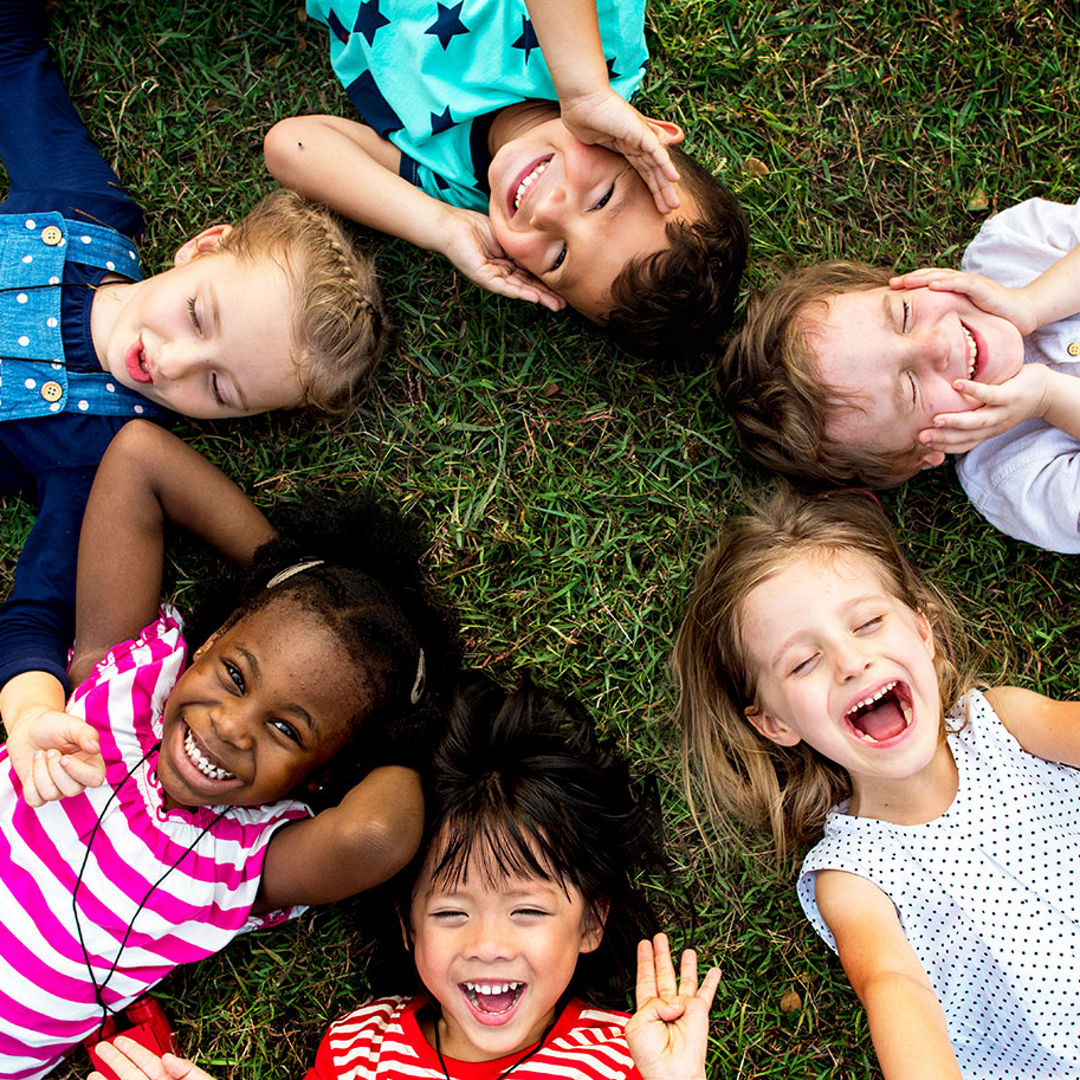 aerial view of children in circle on grass