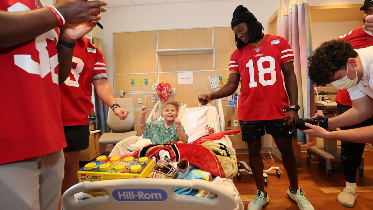 Haven Greyson Smith gives a fist bump to 49ers wide receiver Chris Conley