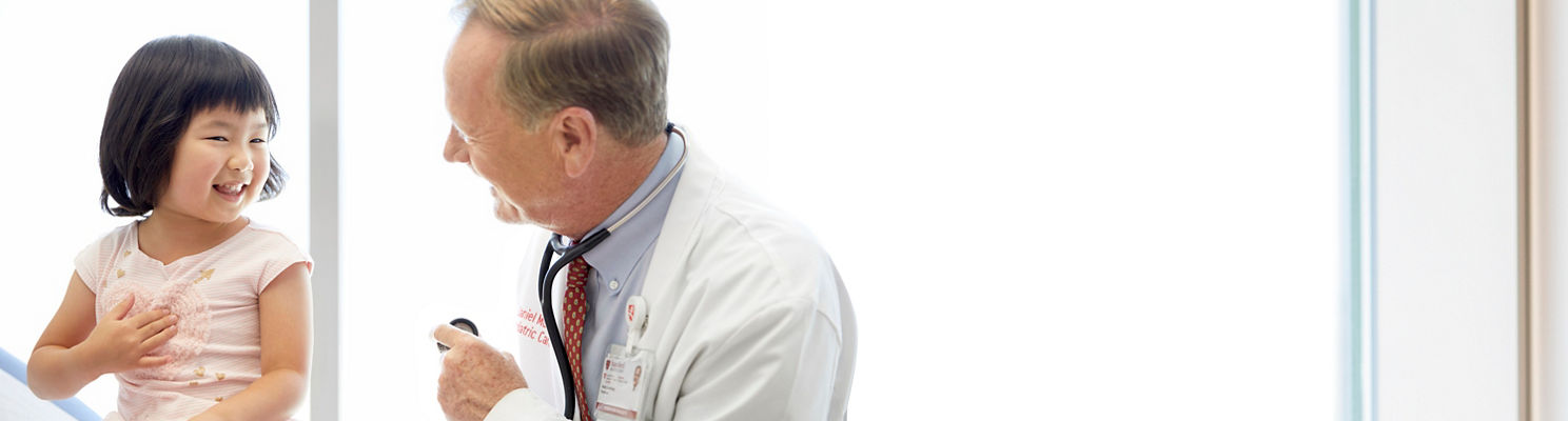 Toddler listening to doctor's heart