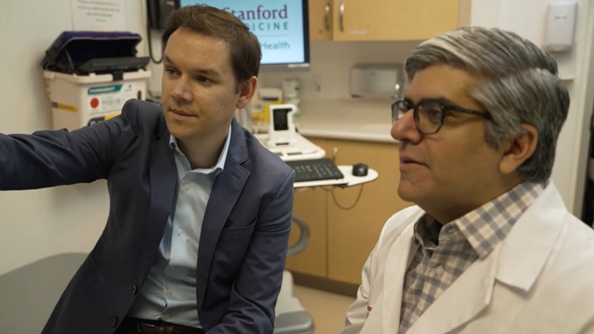 Doctors looking at intestinal ultrasound equipment
