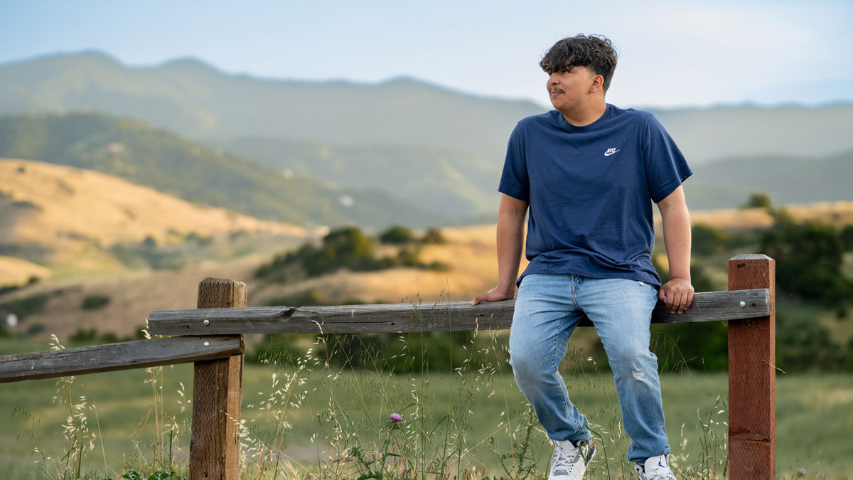 Jesse sitting on a fence