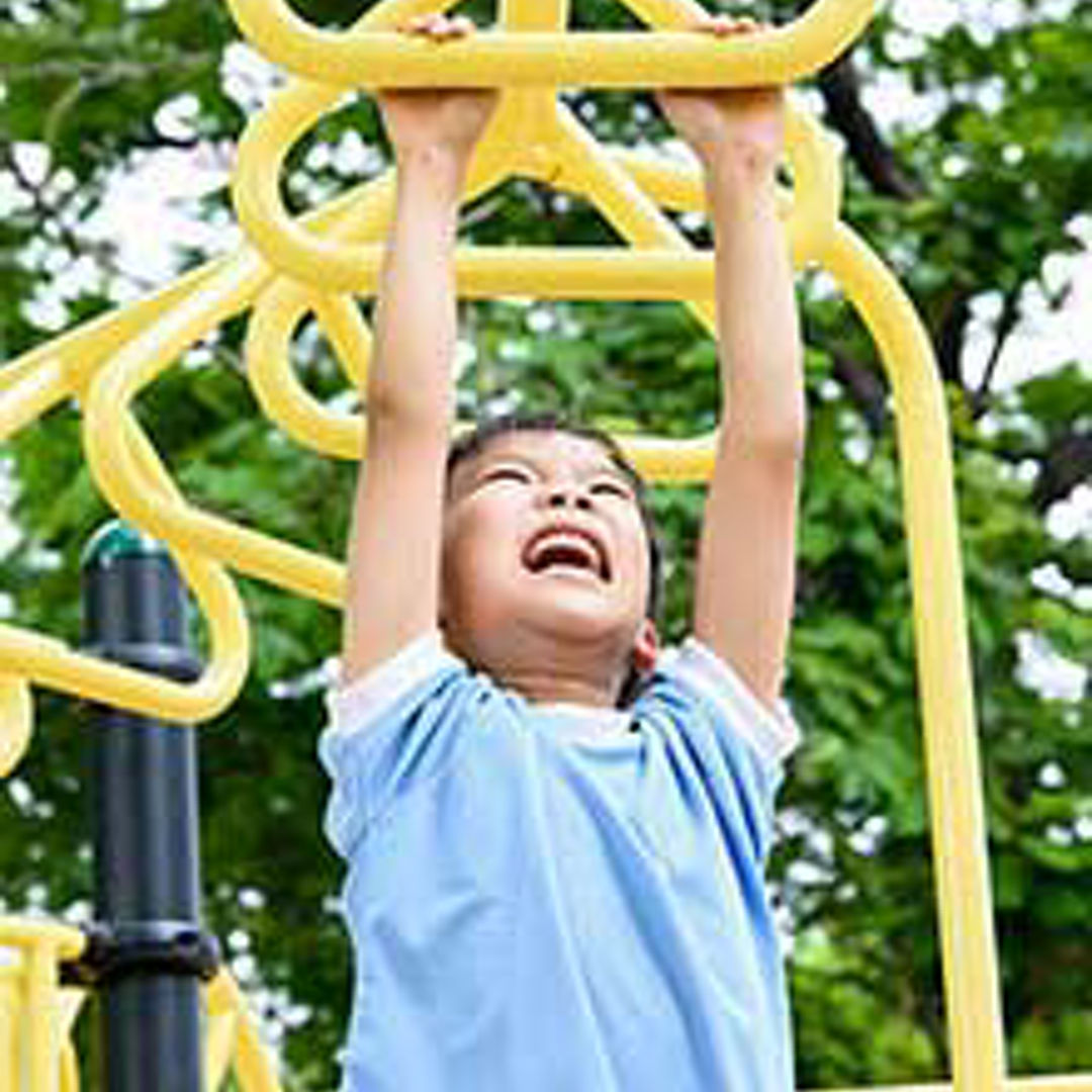 Young child playing on jungle gym