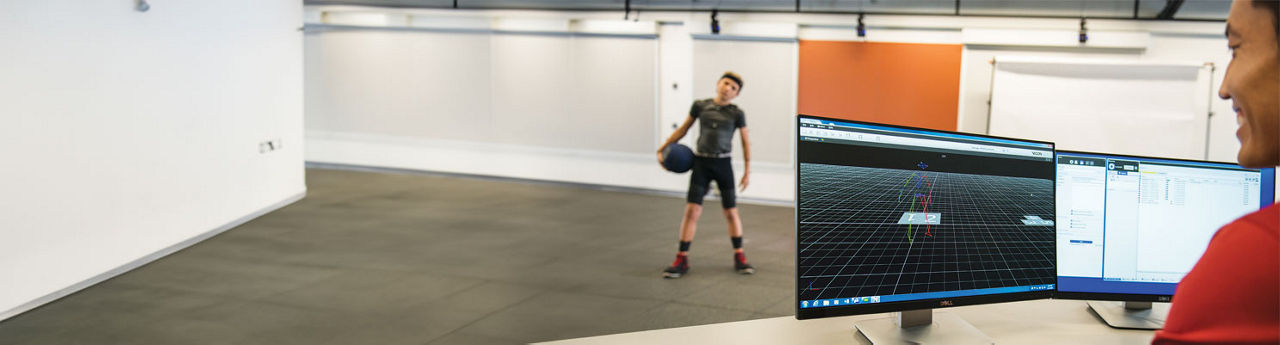 A Stanford Medicine Children's Health Athletic Trainer with a young boy in the Motion and Sports Performance Laboratory