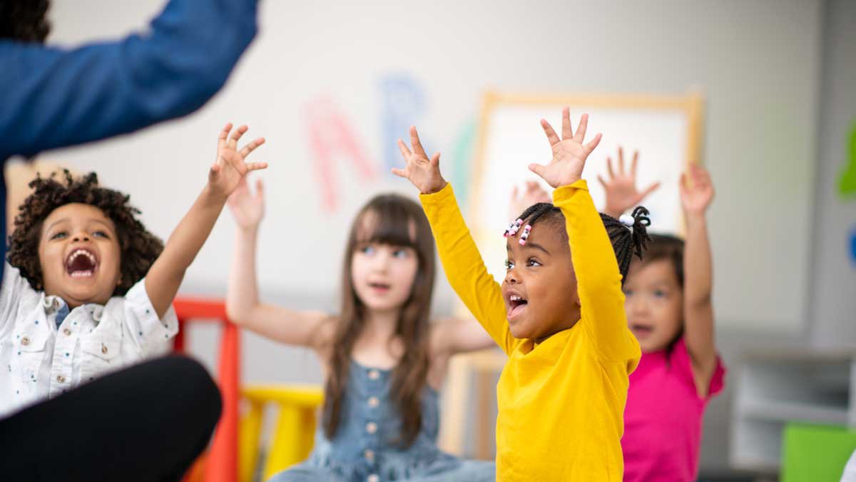 children raising their hands
