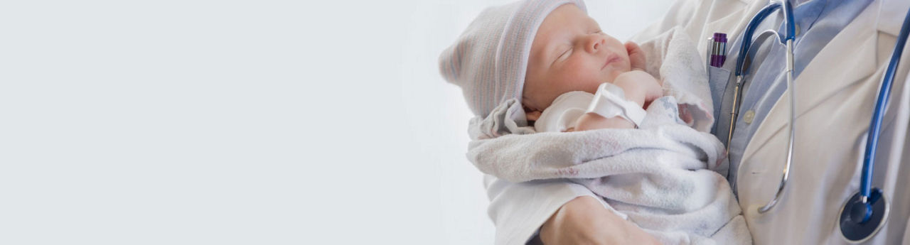 Baby held by a doctor