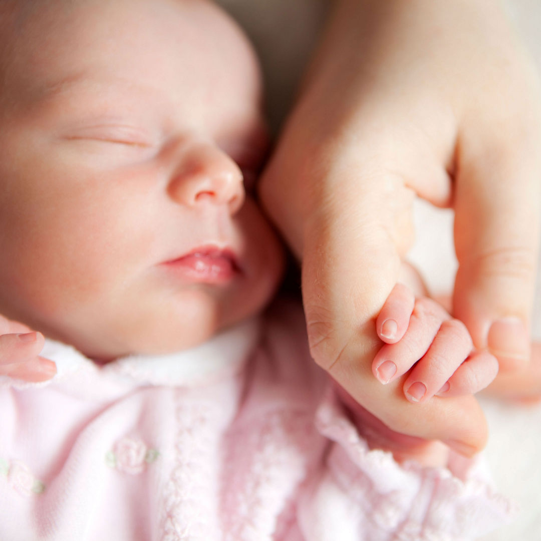 Baby sleeping holding hand