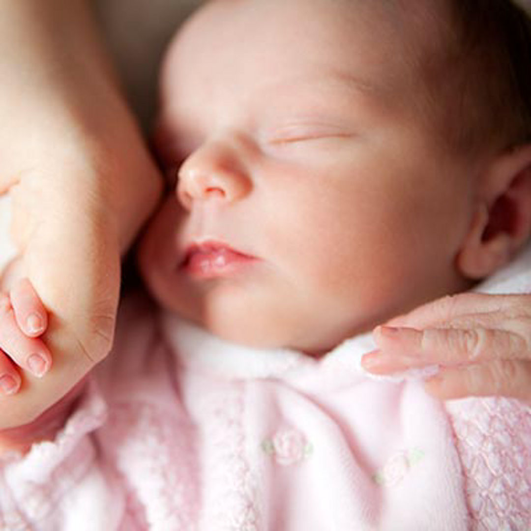 Baby sleeping holding hand