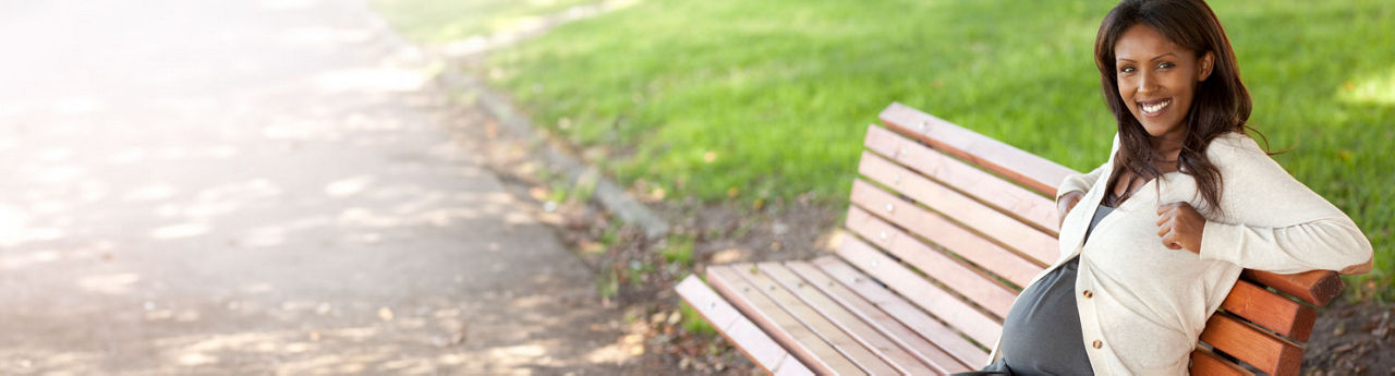 Pregnant mom sitting on a bench