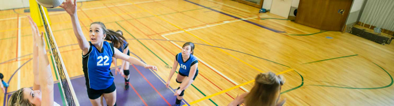 Teenage girl playing volleyball
