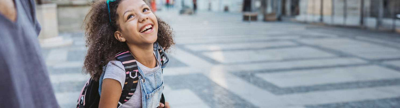 Young girl walking with backpack 