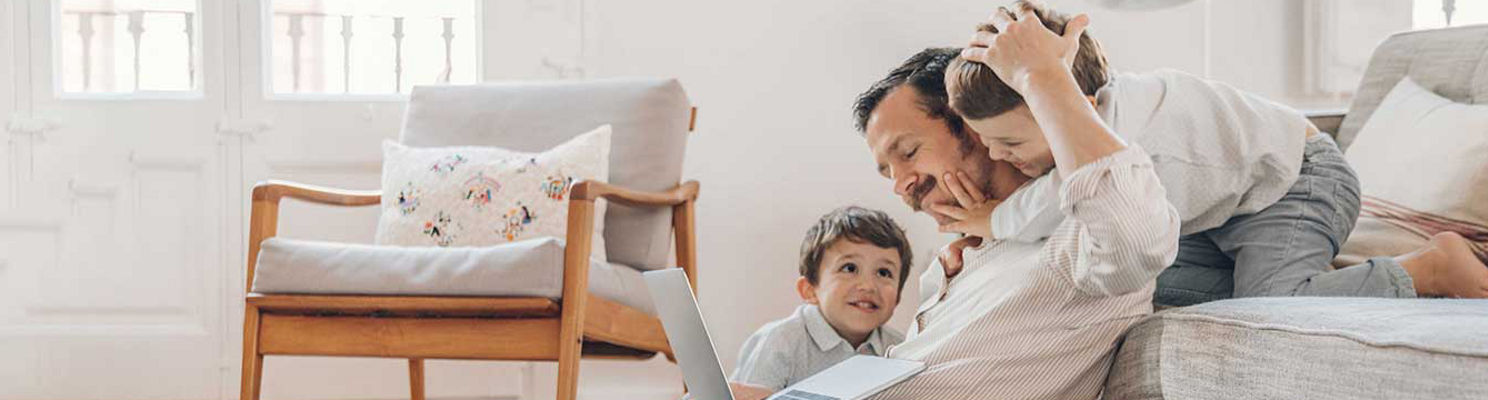 Father viewing his computer with his children