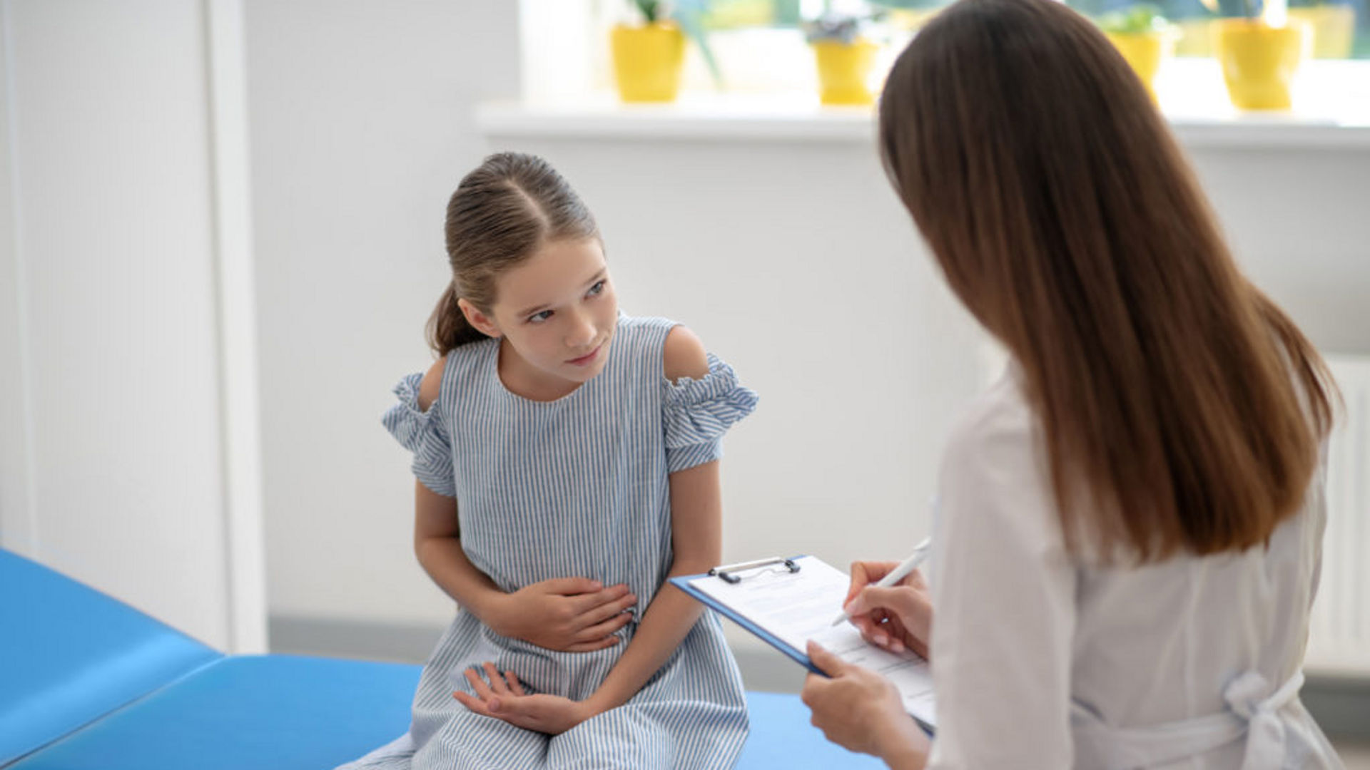 Young girl holding her stomach