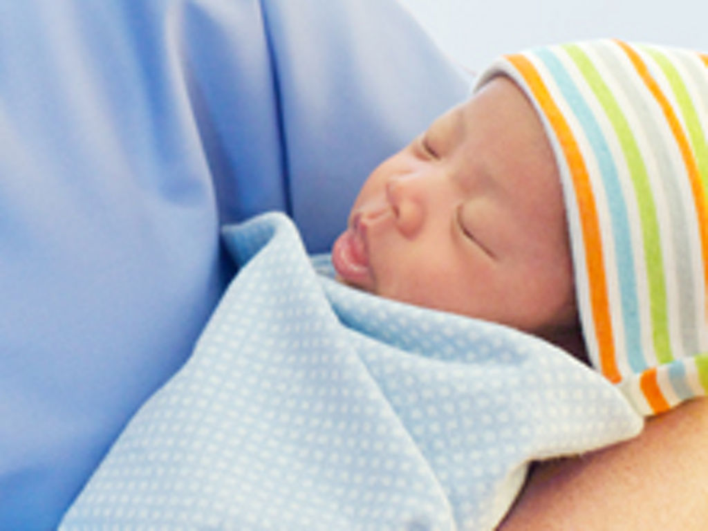 Nurse holding newborn baby