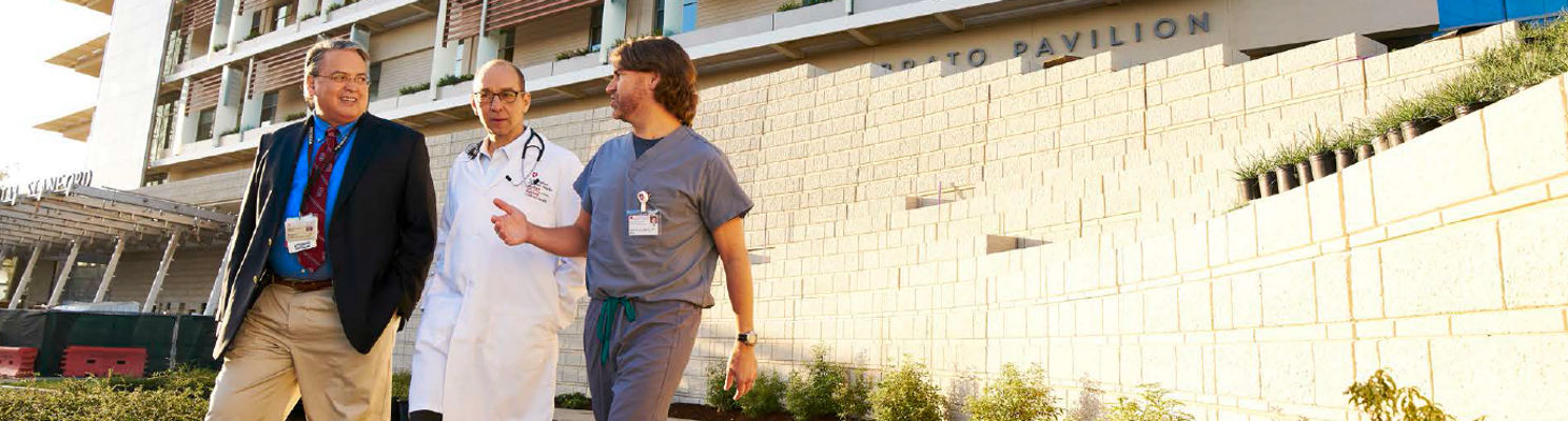 Drs. Concepcion, Cornfield and Sidell walking in front of the new Lucile Packard Children's Hospital Stanford in Palo Alto