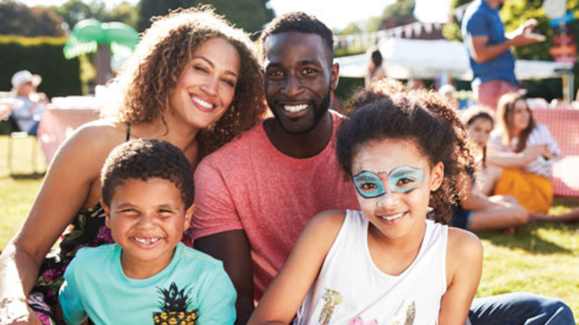 family smiling at a picnic